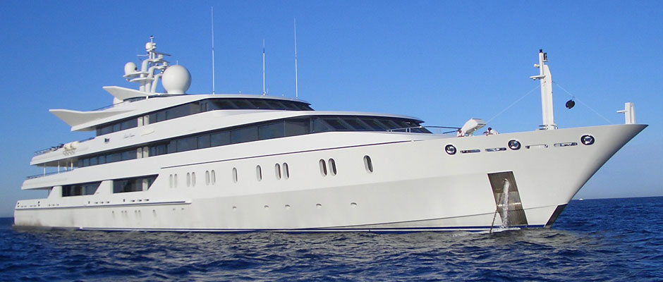 A yacht in the middle of the ocean during the day.